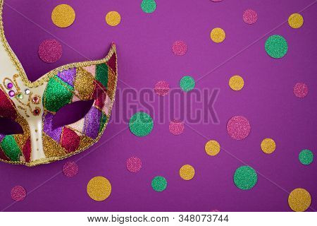 Festive, Colorful Mardi Gras Or Carnivale Mask And Accessories Over Purple Background. Party Invitat