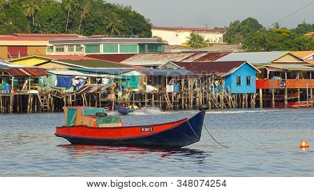 Labuan,malaysia-jan 31,2020:view Of Traditional Fishing Boats With Background Of Water Village Of Pa
