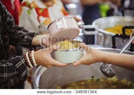 The Concept Of Giving: Homeless People Reach Out To Free Volunteer Meals From Volunteers: Help Feed