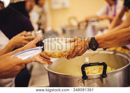 The Concept Of Giving: Homeless People Reach Out To Free Volunteer Meals From Volunteers: Help Feed