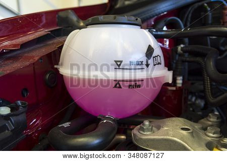Car Engine Coolant Expansion Tank Close-up. Car Service. Car Operation.