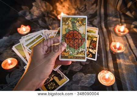 Hand Holding Tarot Card With Candlelight On The Darkness Background For Astrology Occult Magic Illus