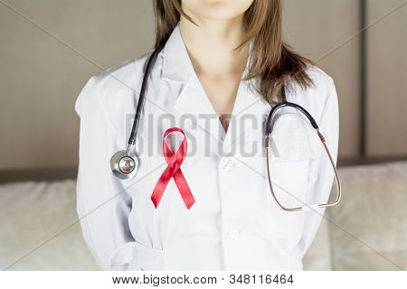 Woman Doctor Holding Red Ribbon Hiv, World Aids Day Awareness Ribbon.