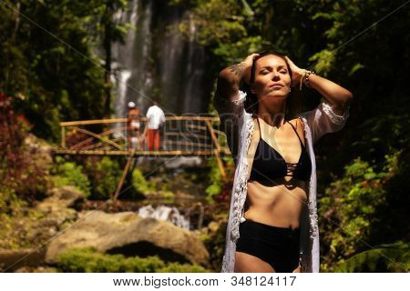Woman near Labuhan Kebo Waterfall located in Munduk, Bali