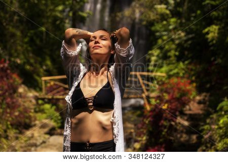 Woman near Labuhan Kebo Waterfall located in Munduk, Bali