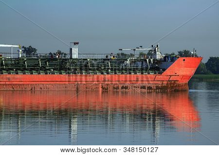Large Metal Transport Ship Bulk Carrier. A Barge Sailing With A Cargo Of Containers From The Port Al