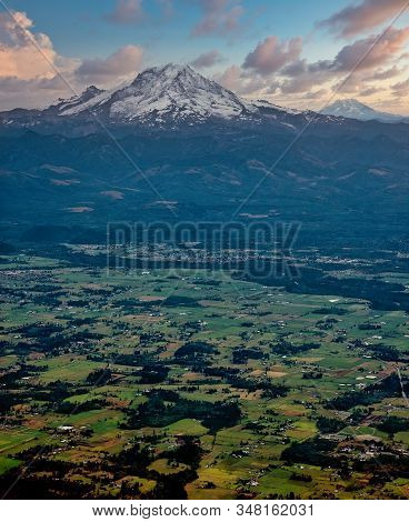 Snow Covered Mountains In The Distance Beyond Low Terrain