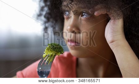 Nice Little Girl Holding Fork With Piece Of Broccoli On, Unappetizing Food