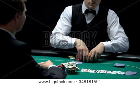 Casino Croupier Matching Bet Of Player Going All-in, Betting All Money And Keys
