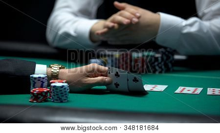 Poker Player Checking Bad Combination Of Cards Dealt By Croupier, Weak Hand