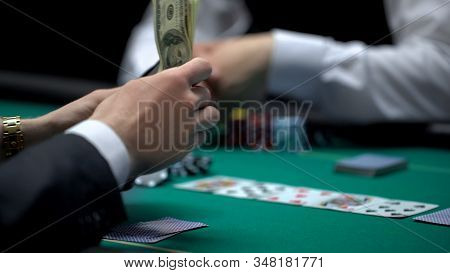 Business Person Pulling Money Out Of Wallet, Risky Poker Game, Bluff Gambling