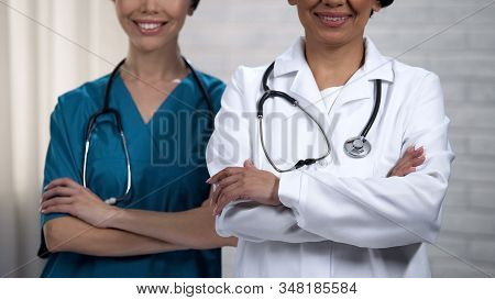 Physicians Smiling And Crossing Hands, Highly Qualified Help Of Medical Staff