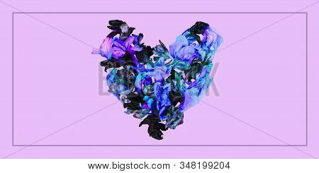 Dry Iris Flowers Laid Out In Center Of Image In Shape Of Heart In Blue, Violet, Purple, Grey On Pink
