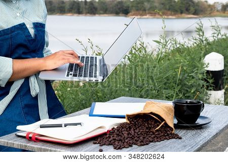 The Woman Inspected The Coffee Bean Quality And Recorded The Results.