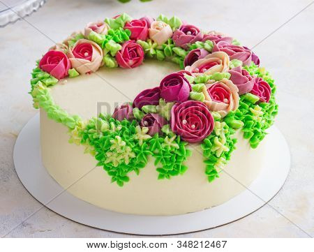 Bright Festive White Cake With Bright Flowers Made Of Cream, A Wedding Cake, For A Woman.