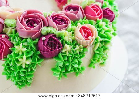 Bright Festive White Cake With Bright Flowers Made Of Cream, A Wedding Cake, For A Woman.