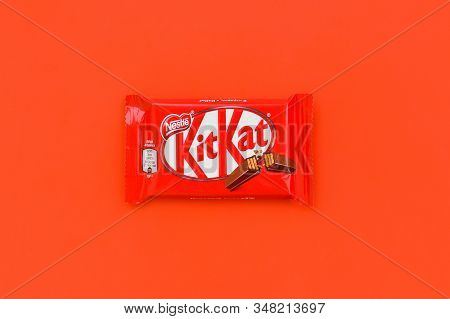 Kit Kat Chocolate Bar In Red Wrapping Lies On Red Background. Kit Kat Created By Rowntrees Of York I
