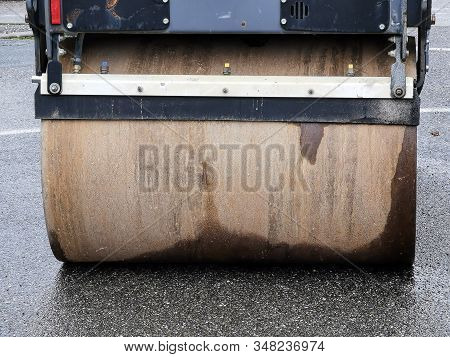 Closeup View Of A Rusty Roll Compactor Used For Road Repair