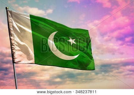 Fluttering Pakistan Flag On Colorful Cloudy Sky Background. Pakistan Prospering Concept.