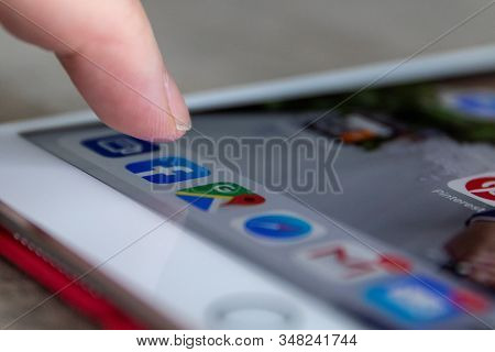 Brecht, Belgium - November 14 2019: A Portrait Of A Finger Of A User Ready To Open The Facebook App 