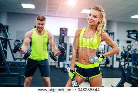 Trainer And Client At The Gym With Sport Equipment. Young And Fit. Healthy Fitness Life Concept. Nic