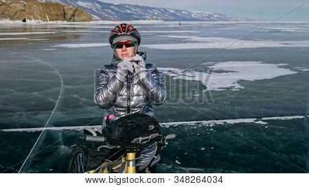 Woman Stands Near Her Bike On Ice. The Girl Cyclist Stopped To R