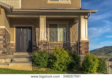 Stairs Leading To Porch And Front Door With Sidelight At The Entrance Of Home