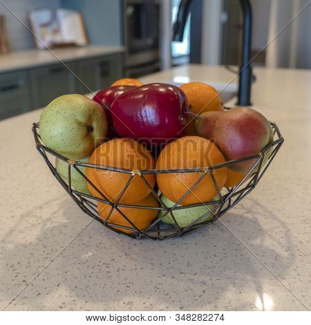 Photo Square Frame Wired Geometric Fruit Basket With Fresh Fruits At The Kitschen Island Of Home