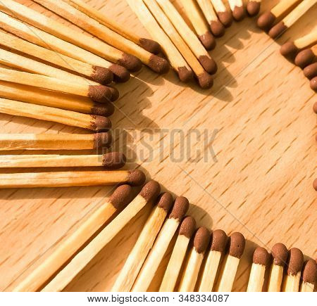 Wooden Safety Matches On A Wooden Background Arranged In The Shape Of A Heart. Matchsticks In The Sh