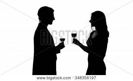 Silhouette Of Couple With Glass Of Wine, Acquaintance, Smiling And Flirting