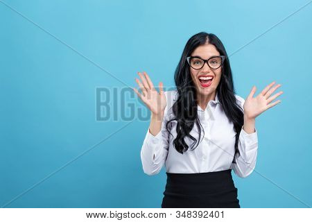 Happy Young Woman Making A Yay Gesture On A Blue Background
