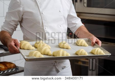 Baker Holding Tray With Croissants. Beautiful Viennoiserie Rolls