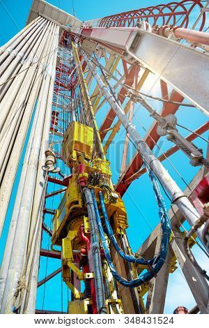 Oil And Gas Drilling Rig Onshore Dessert With Dramatic Cloudscape. Oil Drilling Rig Operation On The
