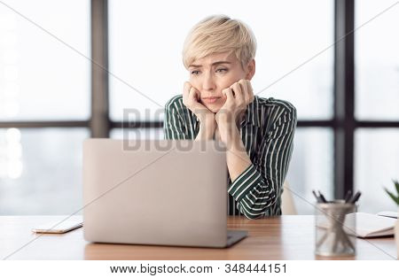 Unhappy Employee. Bored Businesswoman Sitting At Laptop Hating Her Lousy Job In Modern Office. Selec