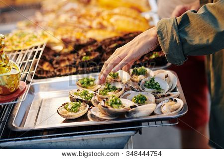 Unrecognizable Woman Choosing Tasty Shellfish At Assian Street Food Market, Horizontal Shot