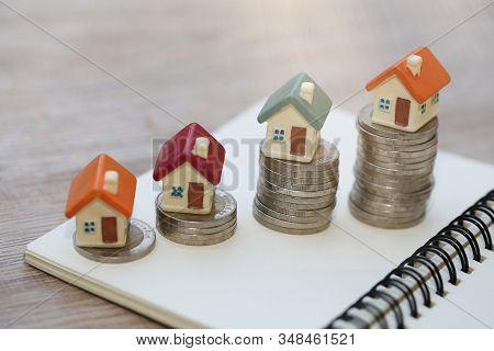 Mini House On Stack Of Coins,money And House,  Mortgage, Savings Money For Buy House And Loan To Bus