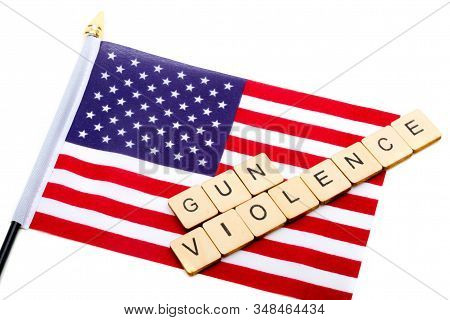 The Flag Of The United States Isolated On A White Background With A Sign Reading Gun Violence
