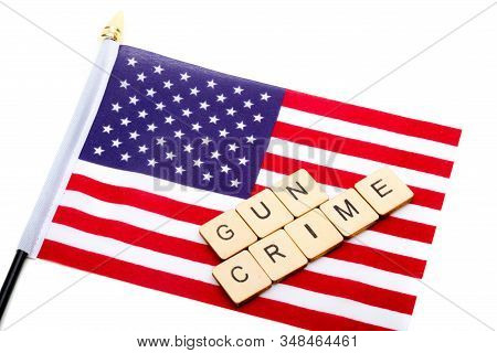 The Flag Of The United States Isolated On A White Background With A Sign Reading Gun Crime