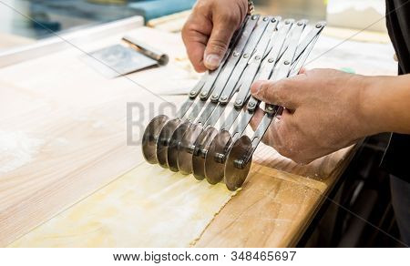 Chef Rolling Dough With A Pasta Machine. Pasta Maker Machine.