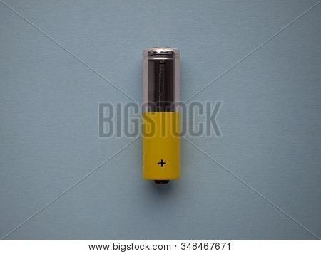 Closeup Silver And Yellow Aa Size Alkaline Batterie Isolated On Blue Background Top View With Copy S