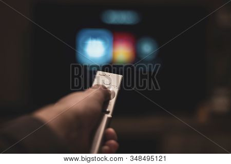 Brecht, Belgium - November 14 2019: A Hand Holding A Television Remote Control With In The Backgroun