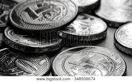 Brazilian Money In Black And White. Financial Crisis Or High Interest Concept. One Real Coins.