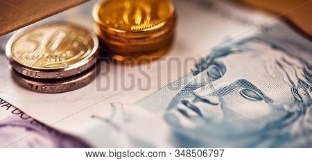 Brazilian Money In Close Up. One Hundred Reais Bill And Brazilian Coins, Concept Of Savings Or Savin
