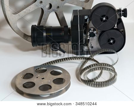 Black Movie Camera. Close Up On A White Background. Isolate View From The Side Where The Lid Of The 
