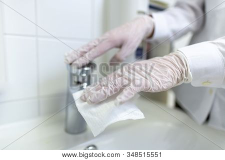 A Nurse Disinfects An Item In A Hospital Room