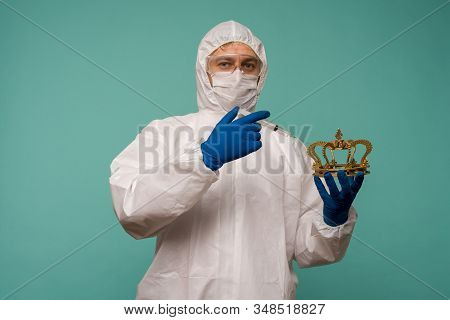 A Male Doctor In Protective Overalls And A Mask Makes An Injection In The Crown. Coronovirus Protect