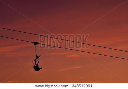 Ski Chair Lift In The Mountains At Pink Sunrise