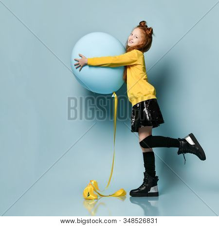 Ginger Teenage Kid With Fancy Hairstyle In Yellow Sweatshirt, Black Skirt, Knee-highs, Boots. Smilin