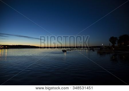 Night Shot Of Northern Sea With Port And Sunset, Blue Skies And Water, Calm Sea.