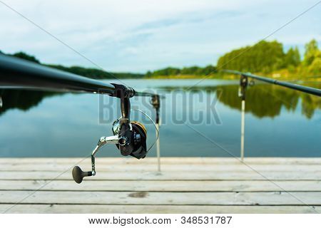 Carp Fishing On Beautiful Blue Lake With Carp Rods And Rod Pods In The Summer Morning. Fishing From 
